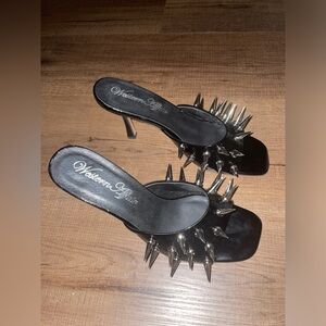 Black spike studded heels by brand Western Affair